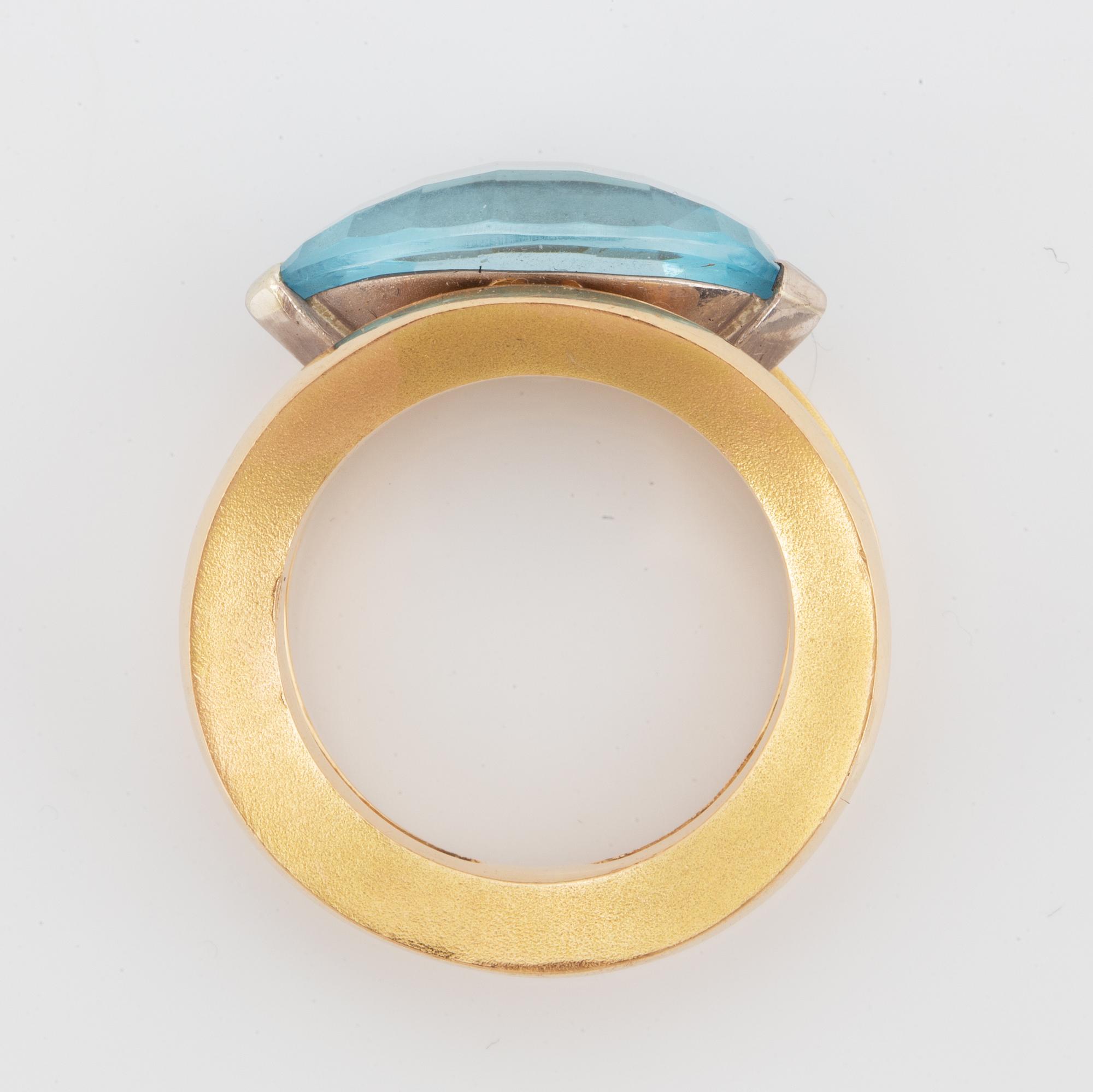 18K gold and navette shaped blue topaz.