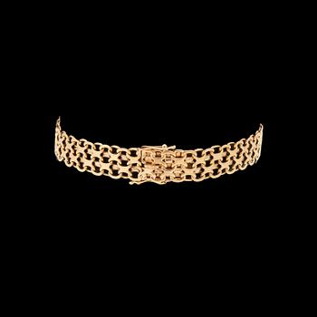 An 18K gold x-link bracelet.