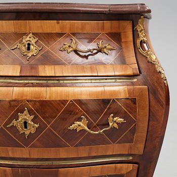 A Swedish rosewood-veneered Rococo chest of drawers, later part of the 18th century.