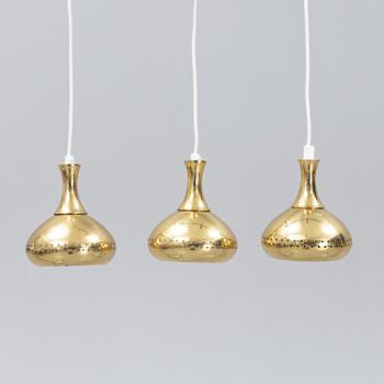 A set of three brass pendule lights, second half of the 20th Century.