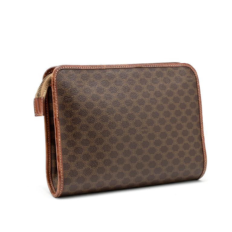 CÉLINE, a brown coated monogram canvas clutch bag.