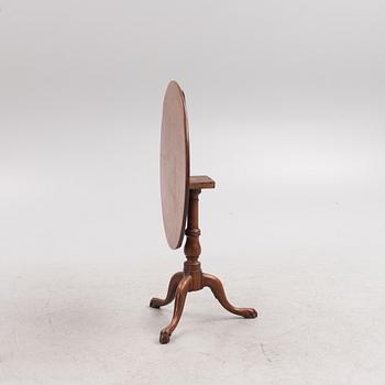 A tilt-top table, 19th century.