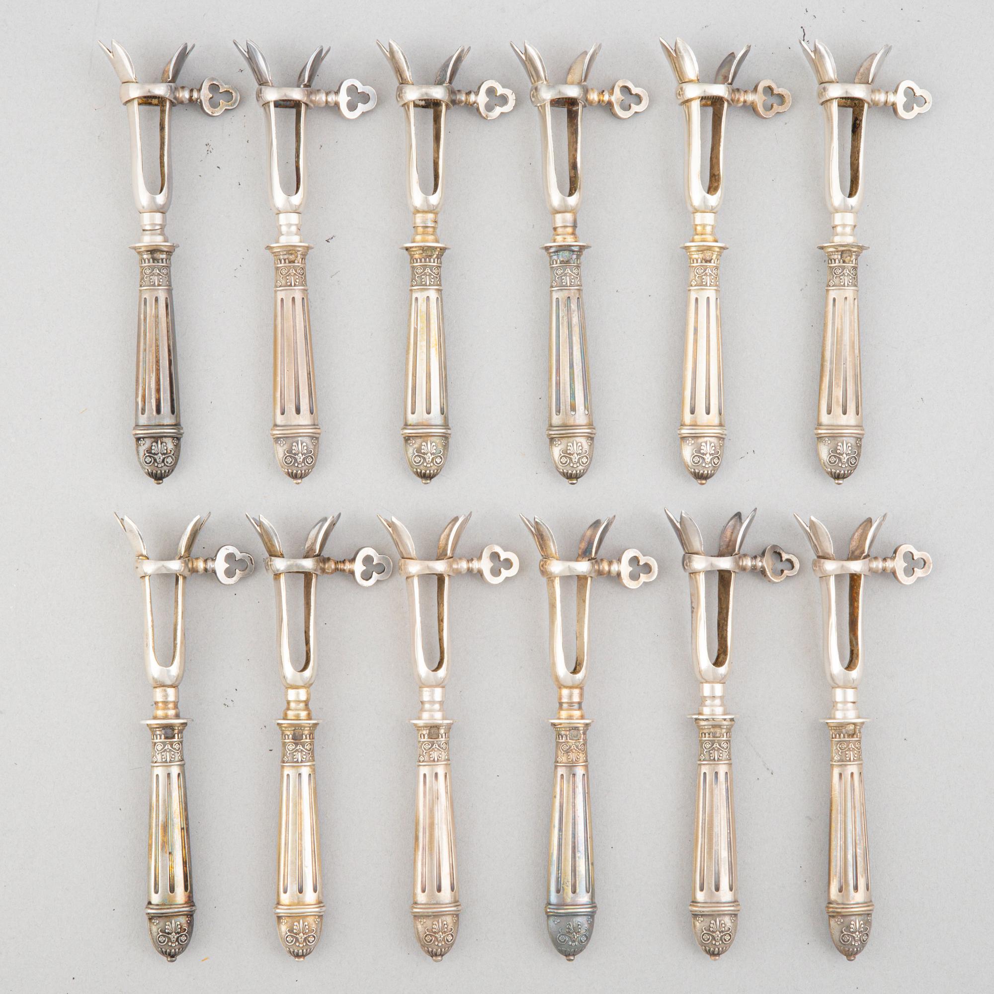 A set of six French silver pork chop holders, circa 1900.