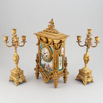 A late 19th century table clock and candelabra, probably France.