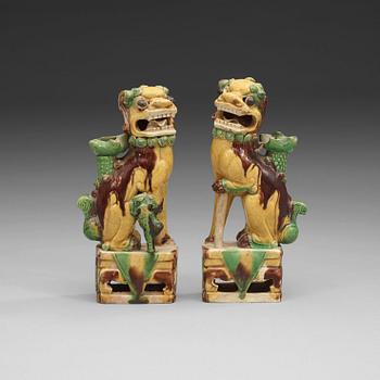 1478. A pair of bisquit joss stick holders in the shape of buddhist lions, Qing dynasty, Kangxi (1662-1722).