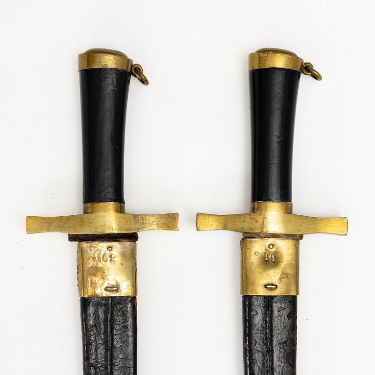 Two Swedish cutlasses 1856 pattern, with scabbards.