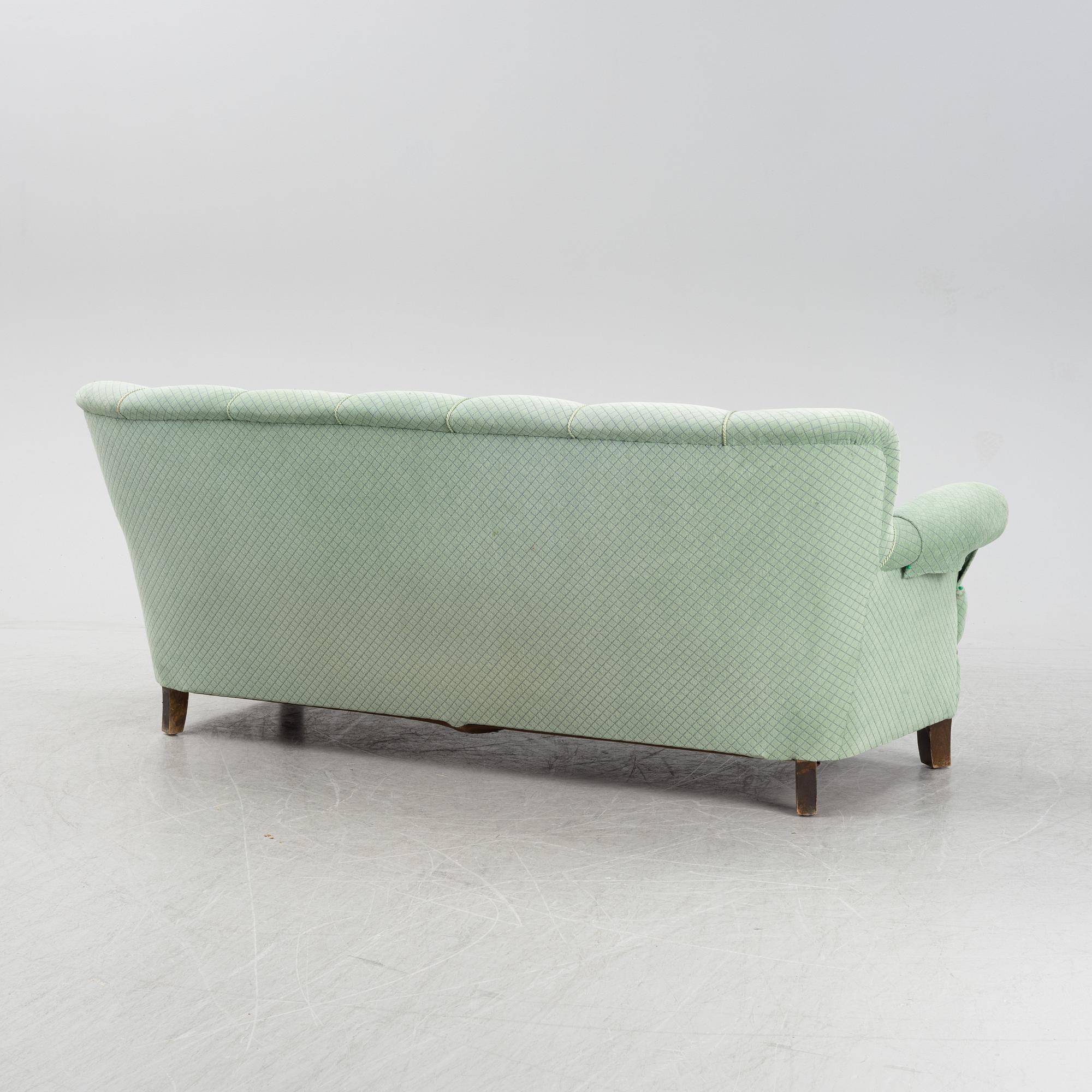 A mid 20th Century sofa and easy chair.