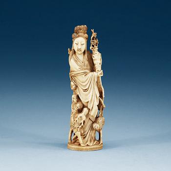 1318. A carved ivory figure of a lady with a deer, crane and a flower vase, late Qing dynasty, 19th Century.