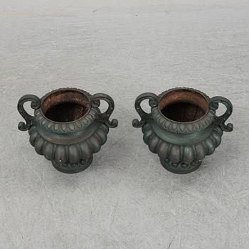A 20th Century pair of cast iron flower pots.