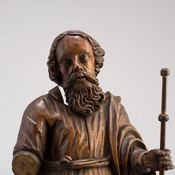 A 17TH CENTURY CARVED WOOD SCULPTURE OF A SAINT.