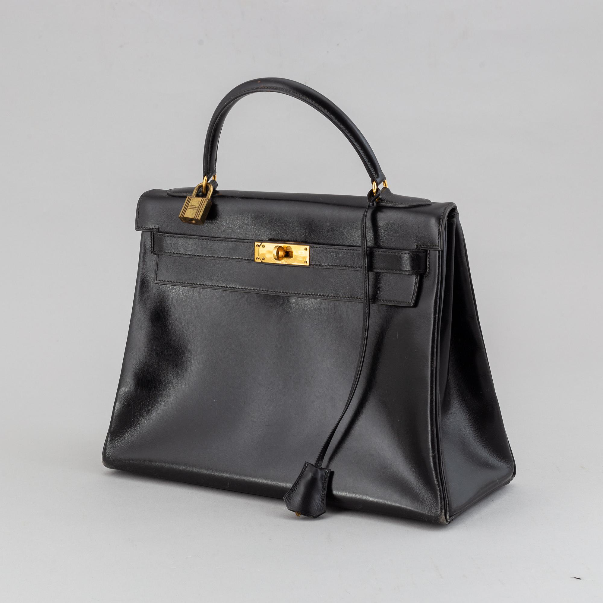 Hermès,a black leather 'Kelly 32' handbag, 1975.