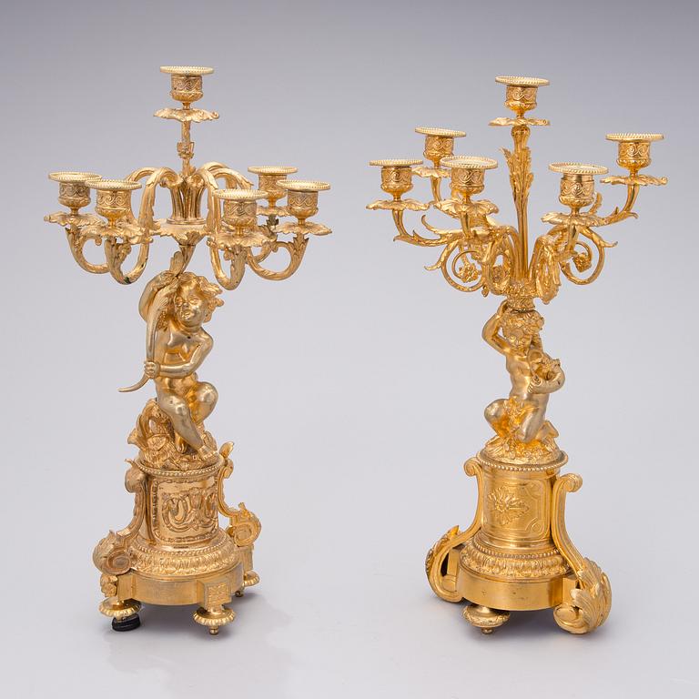 Two similar mid 19th century candelabra in gilt bronze,