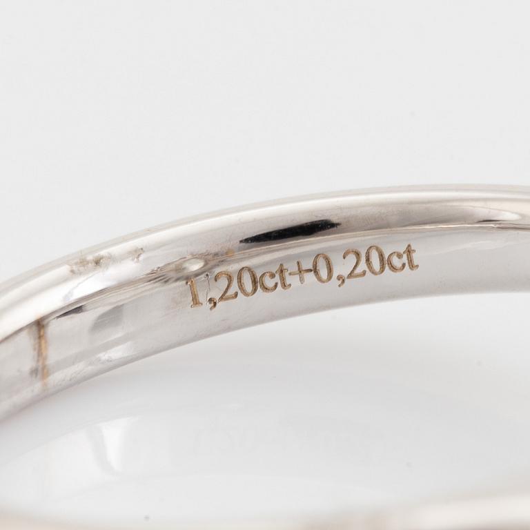 An 18K white gold ring set with  a pear brilliant-cut diamond.