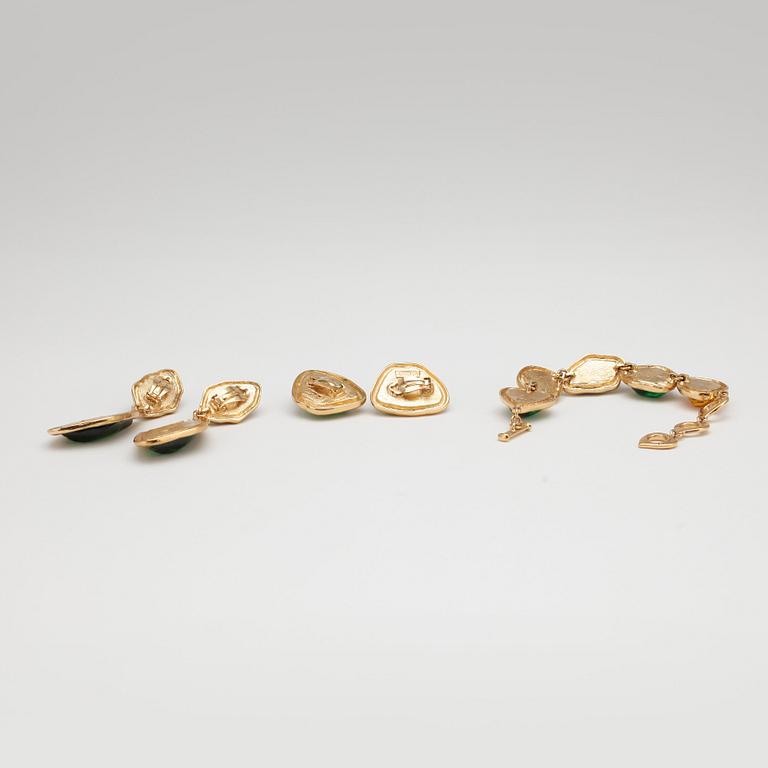 YVES SAINT LAURENT, a gold colored bracelet with glass stones  and two pairs of earclips.