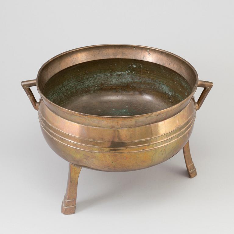 A Swedish 18th/19th century brass pot on three legs.