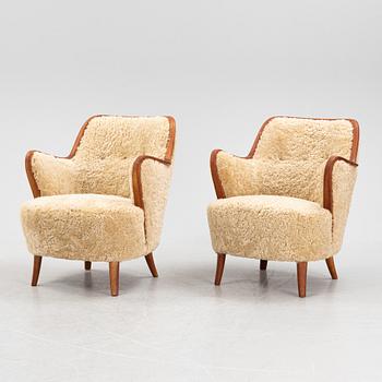 A pair of teak and sheepskin Swedish Modern 1950's easychairs.