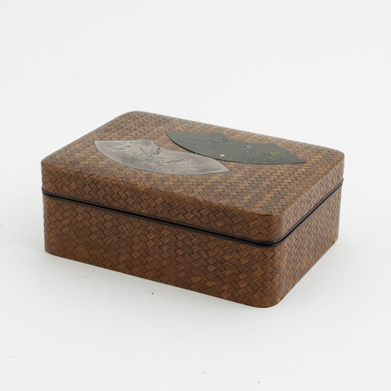 A Japanese woven bamboo box with metal inlaid shibuichi top, presumably Meji period (1868-1912).