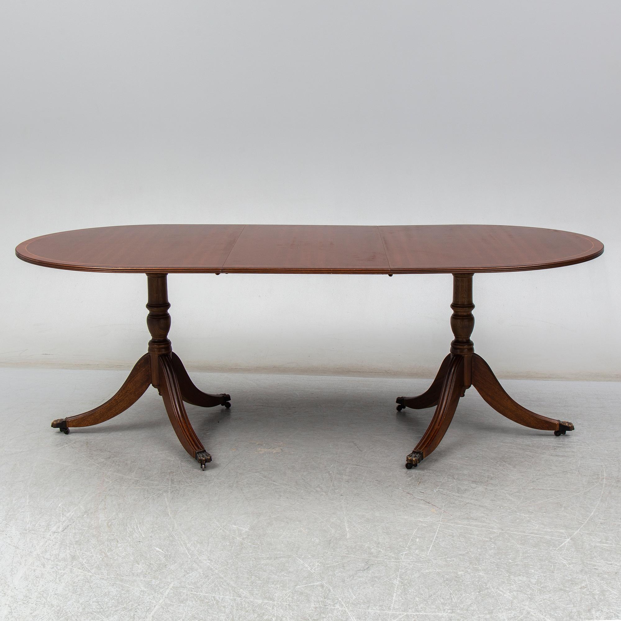 A late 20th century English dining table. One leaf included.