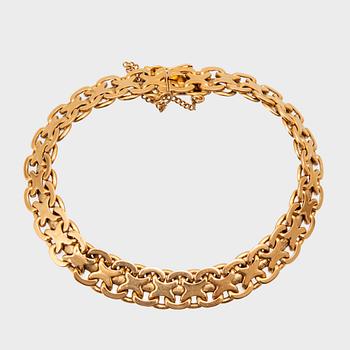 An 18K gold bracelet.