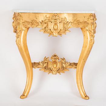 A mirror and console table from around the year 1900.