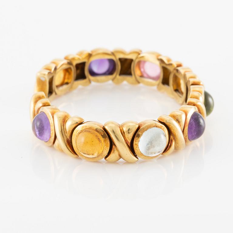 Bracelet in 18K gold set with cabochon-cut citrine, amethyst, pink tourmaline, peridot, and aquamarine.