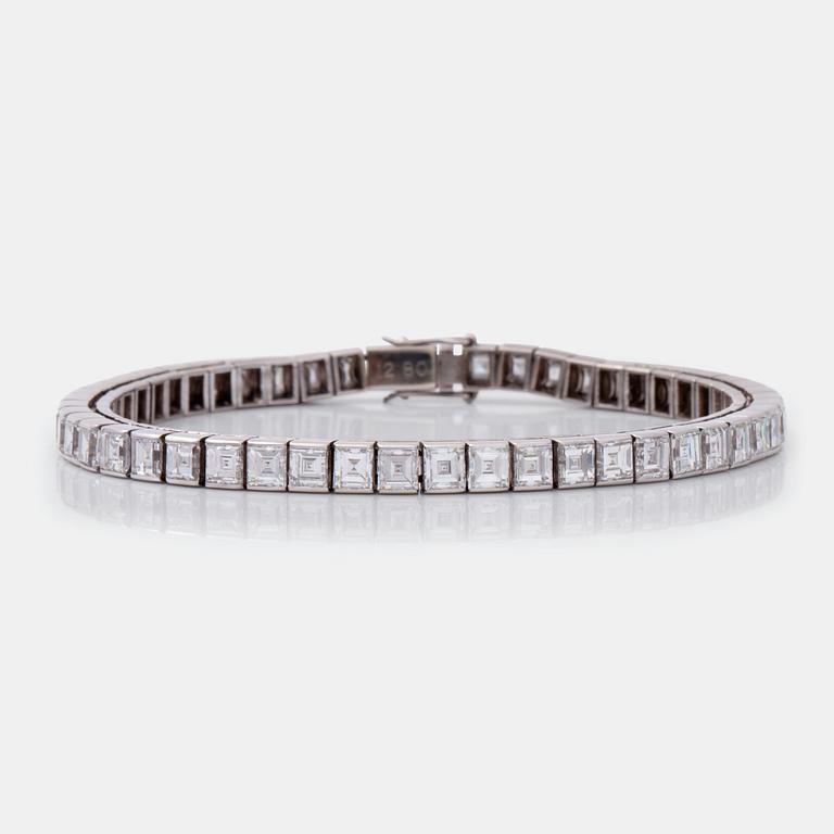 A square step-cut diamond line bracelet. Total carat weight 12.80 cts.