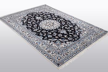 A rug, Nain, part silk, ca 242 x 167 cm.