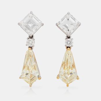 1085. A pair of Fancy Light Yellow and colourless diamond earrings. Total carat weight 8.07cts.