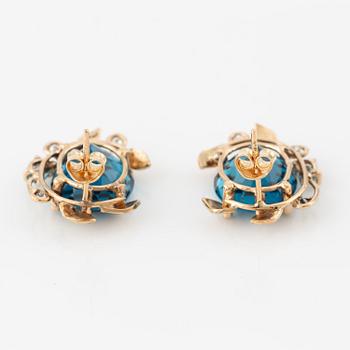 Earrings with blue topazes and brilliant-cut diamonds.