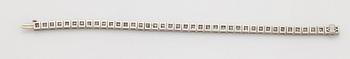 A platinum bracelet set with carré cut diamonds.