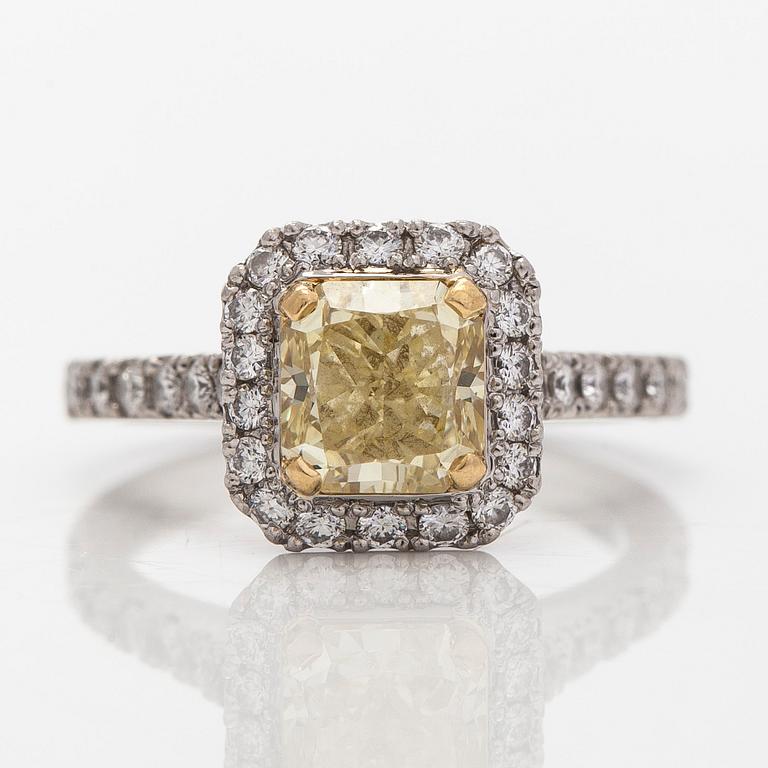 platinum ring with yellow radiant-cut diamond and brilliant cut diamonds.