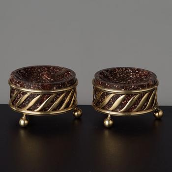 A pair of gilt silver and porphyry salts, by Gustaf Folcker, Stockholm 1827.