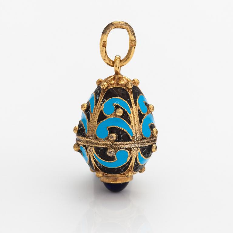 A gilded brass pendant with enamel and glass stones.