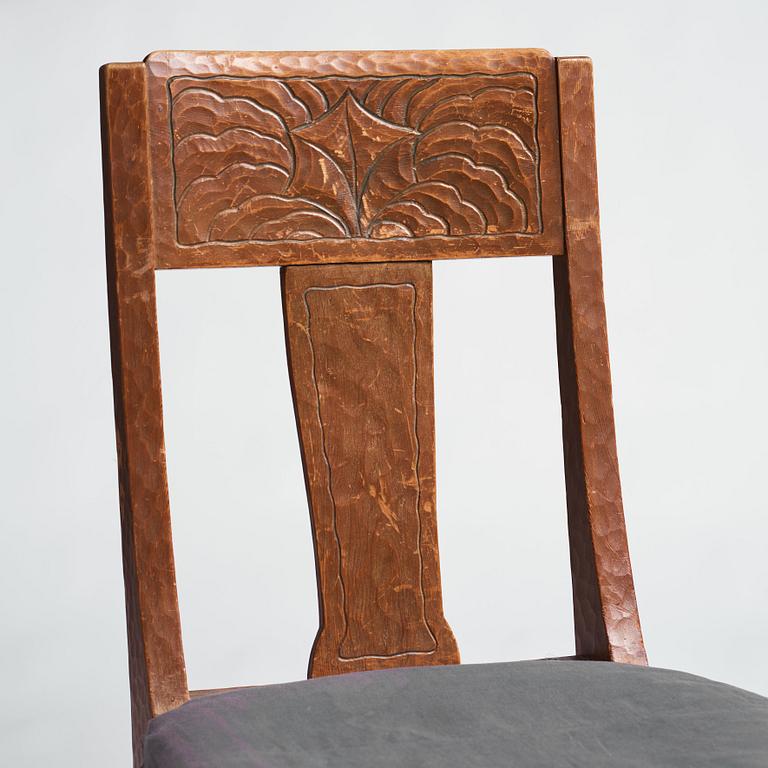 Otto Wretling, attributed to, an Art Nouveau pine 'partner's desk' with two chairs, Sweden, early 20th century.