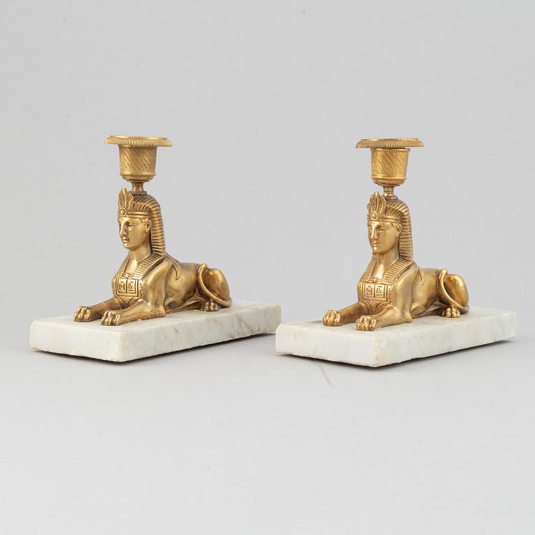 A pair of empire style 19th century candlesticks.