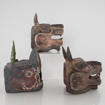 Four Tibetan/South East Asian wooden decorations, 20th century.