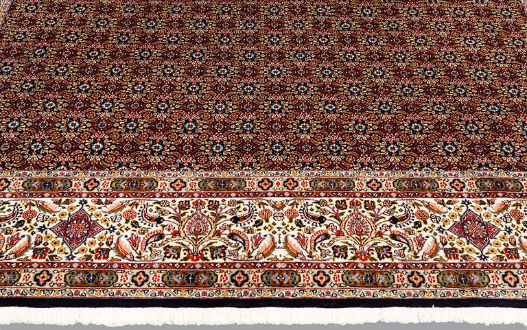 A Moud part silk carpet, signed, 335 x 250 cm.
