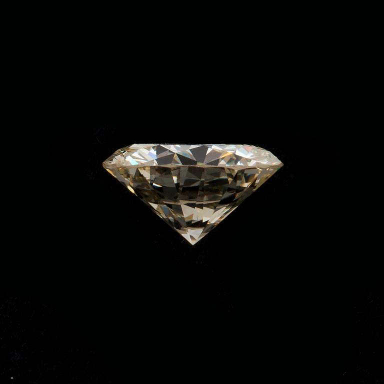 A loose 6.55 ct diamond. Light Yellow/VVS2-VS1.
