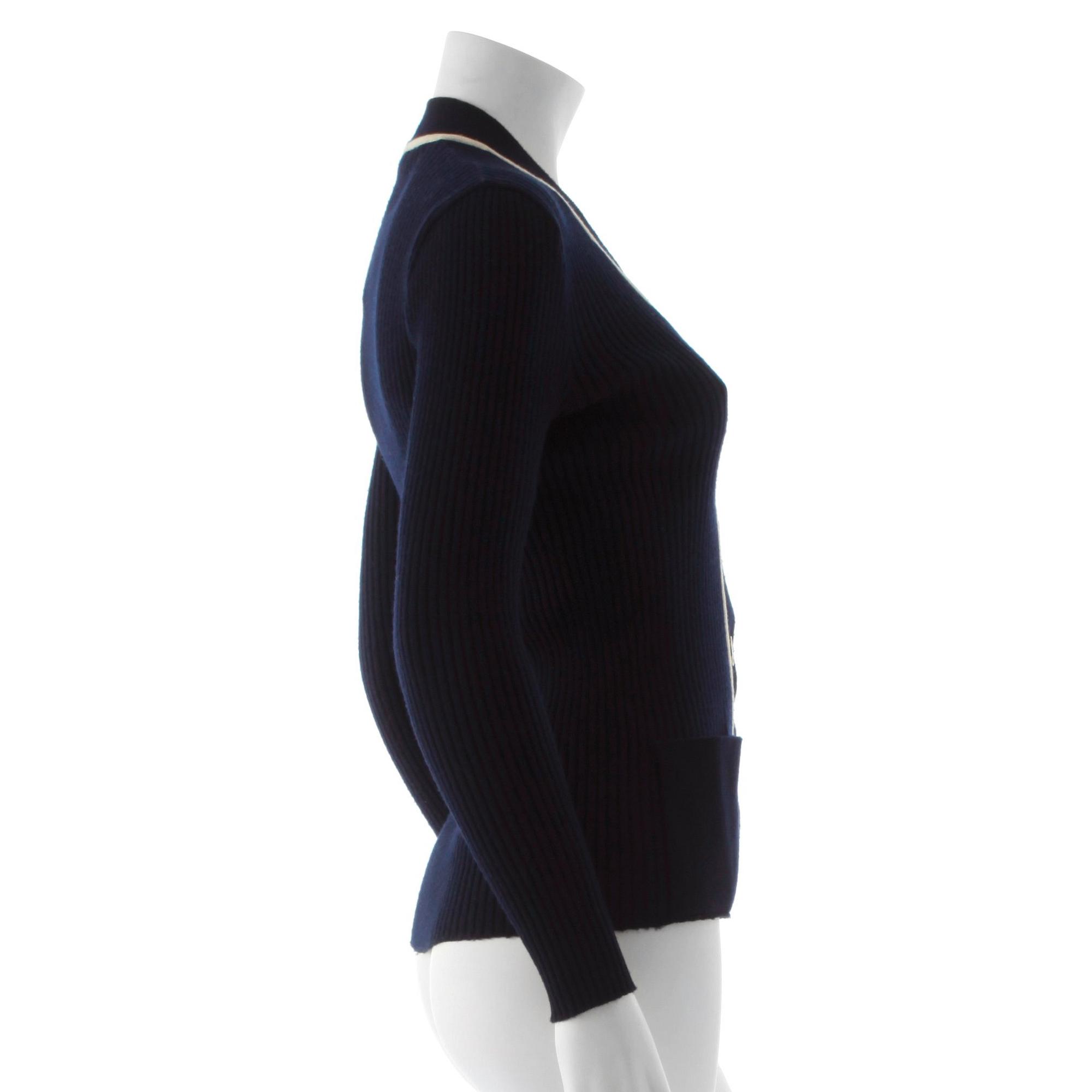 CÉLINE, a navy blue cardigan.