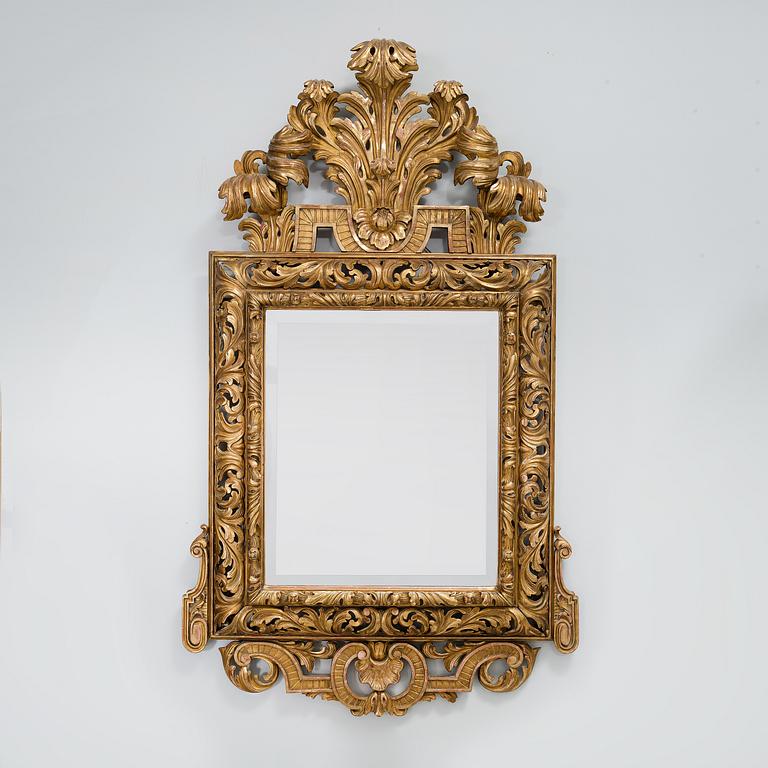 A baroque style mirror, around the year 1900.