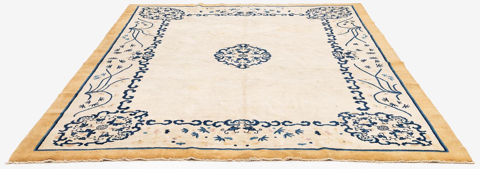 An antique Chinese carpet, 404 x 304 cm.