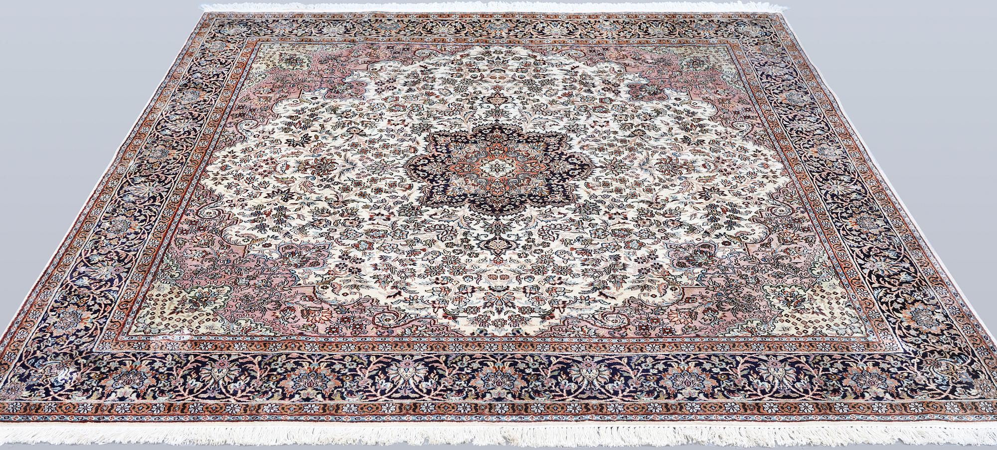 A Kashmir silk rug, approx. 215 x 212 cm.