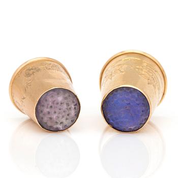 Two 18K gold thimbles with blue and lilac stones.