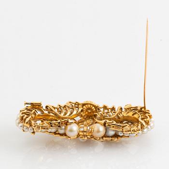 An 18K gold brooch/pendant set with old- and rose-cut diamonds and pearls.