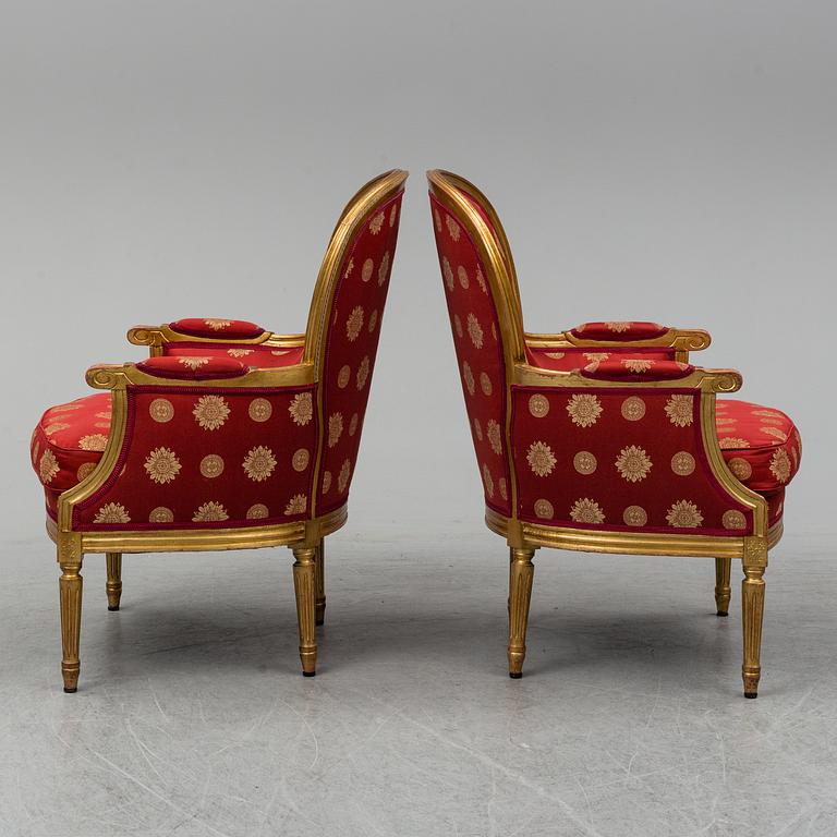 A pair of Louis XVI-style armchairs.