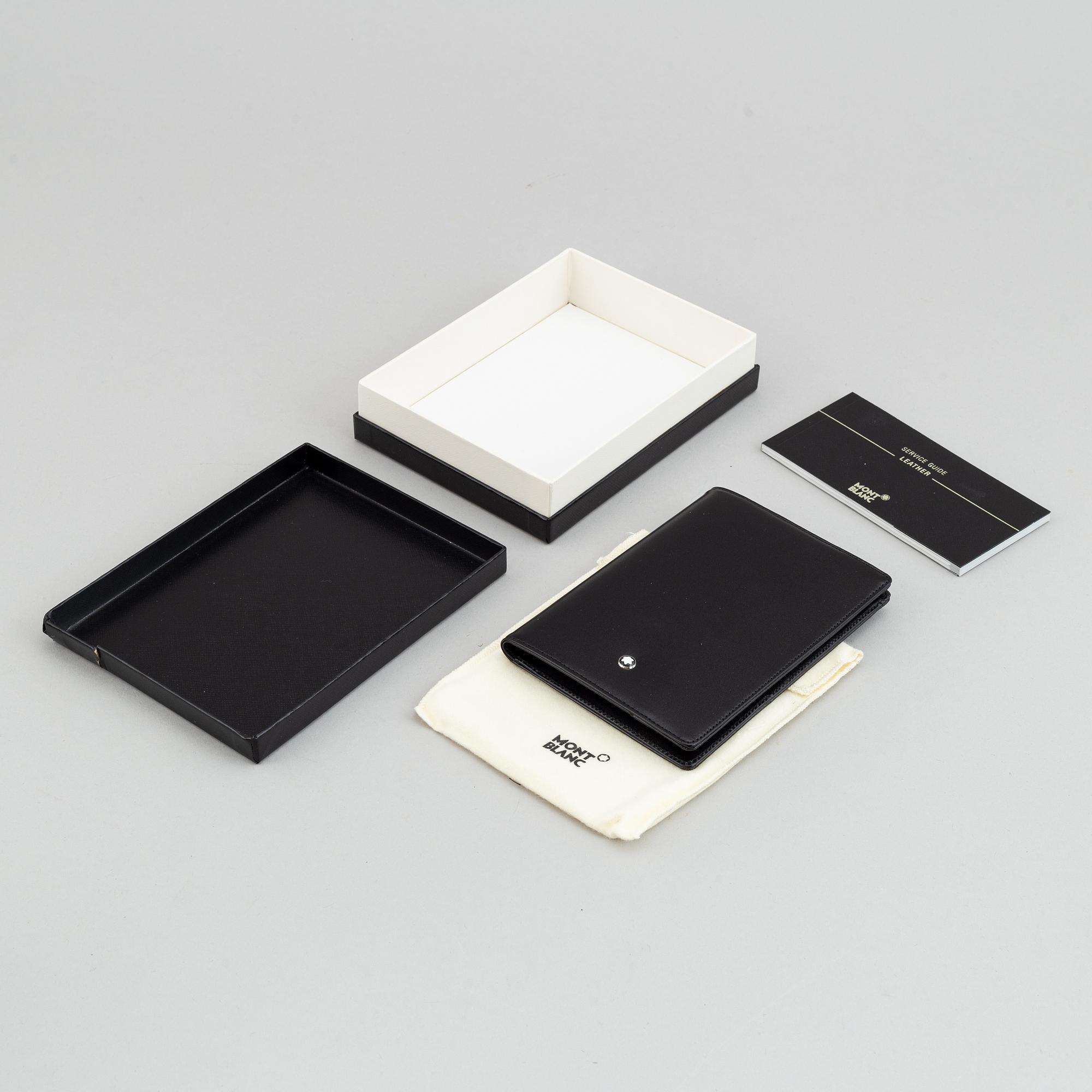 MOntblanc, a ball point pen and leather passport holder.
