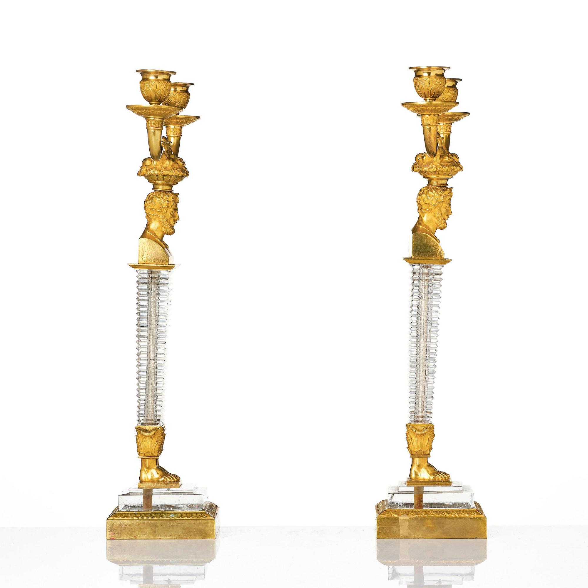 A pair of Empire ormolu and cut glass two-branch candelabra, Paris, early 19th century.