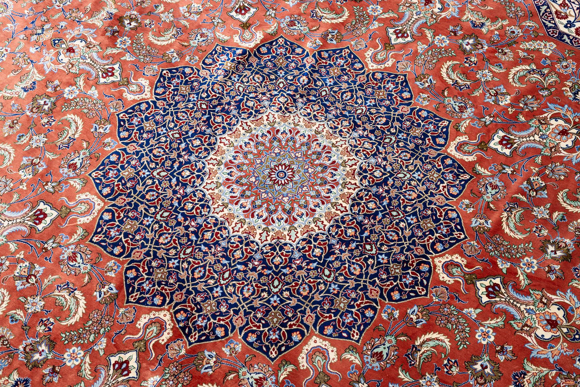An Oktagonal  silk Qum rug, Central Persia, signed, c. 250 x 250 cm.
