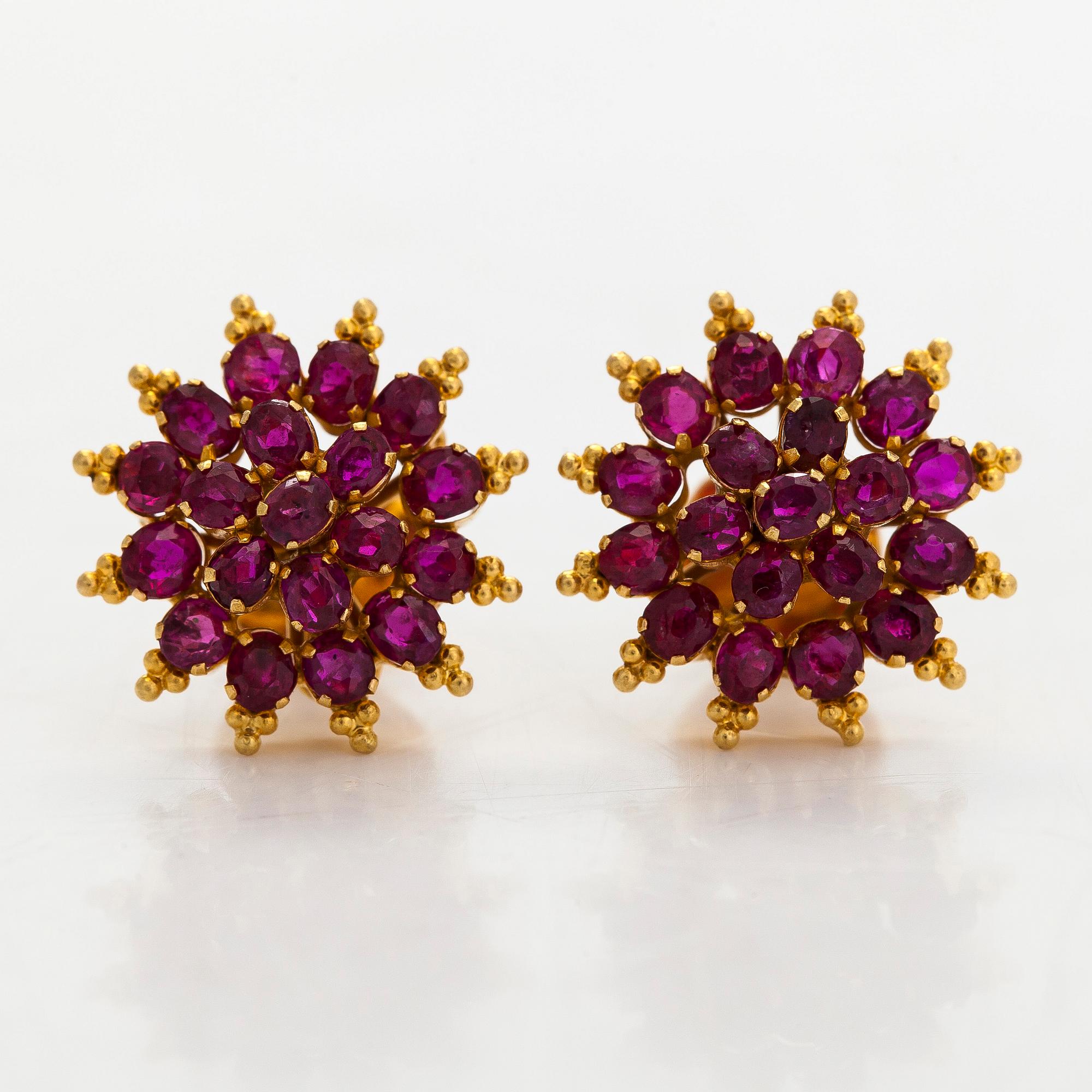 A pair of 18K gold earrings and rubies.