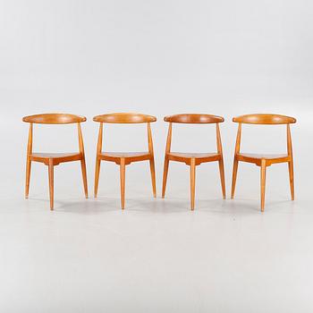 Four chairs named "Hjertestolen" designed by Hans J Wegner and a dining table from Troed.